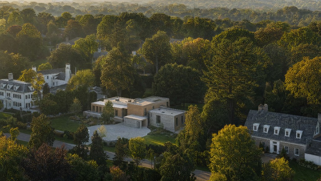 Aerial view of the subject property in its wooded setting